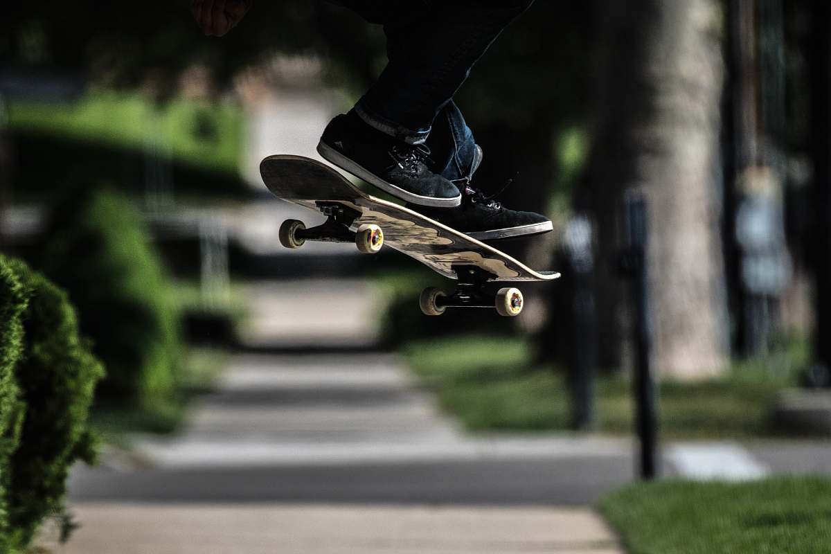 sports person riding on skateboard doing exhibition trick skateboard