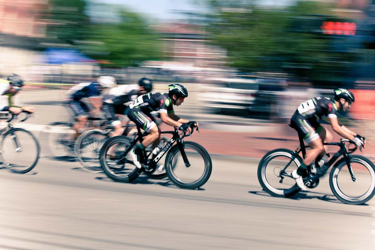 bicycle time lapse photography of bikers cyclist