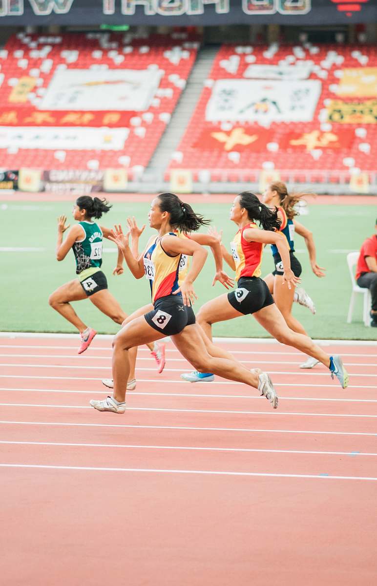 person women running on track field running track