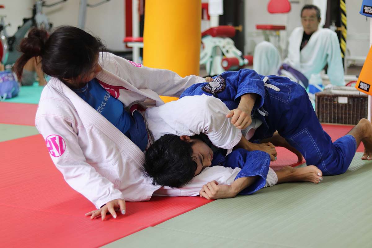 human girl and boy doing Brazilian jiu-jitsu judo