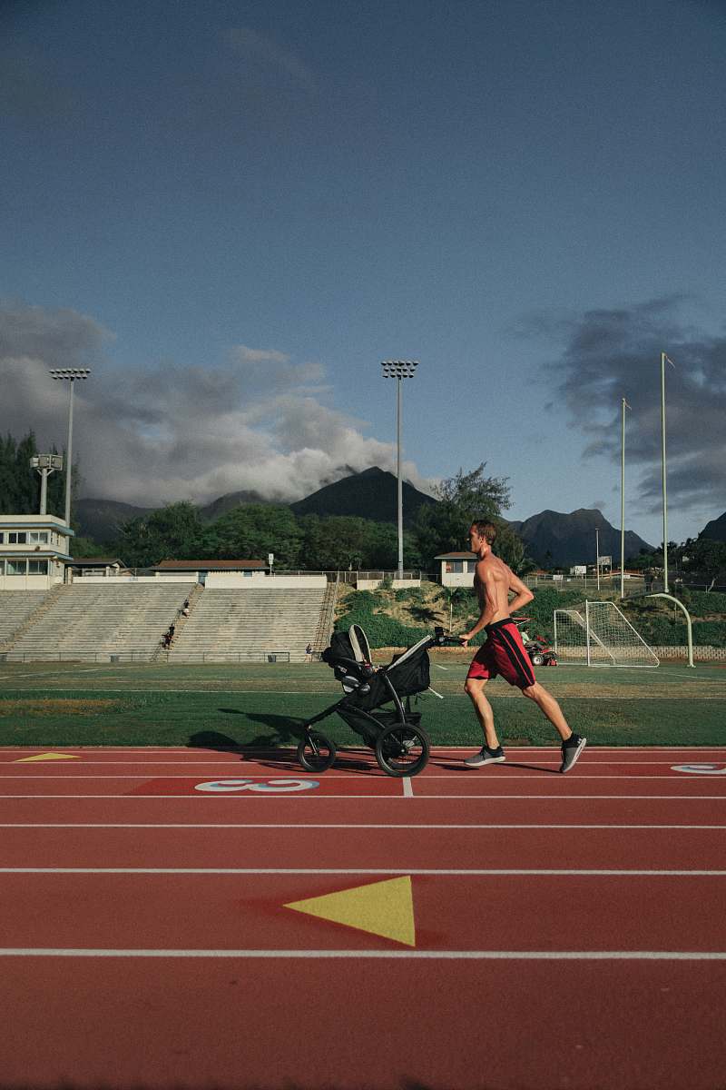 human man running while holding stroller person
