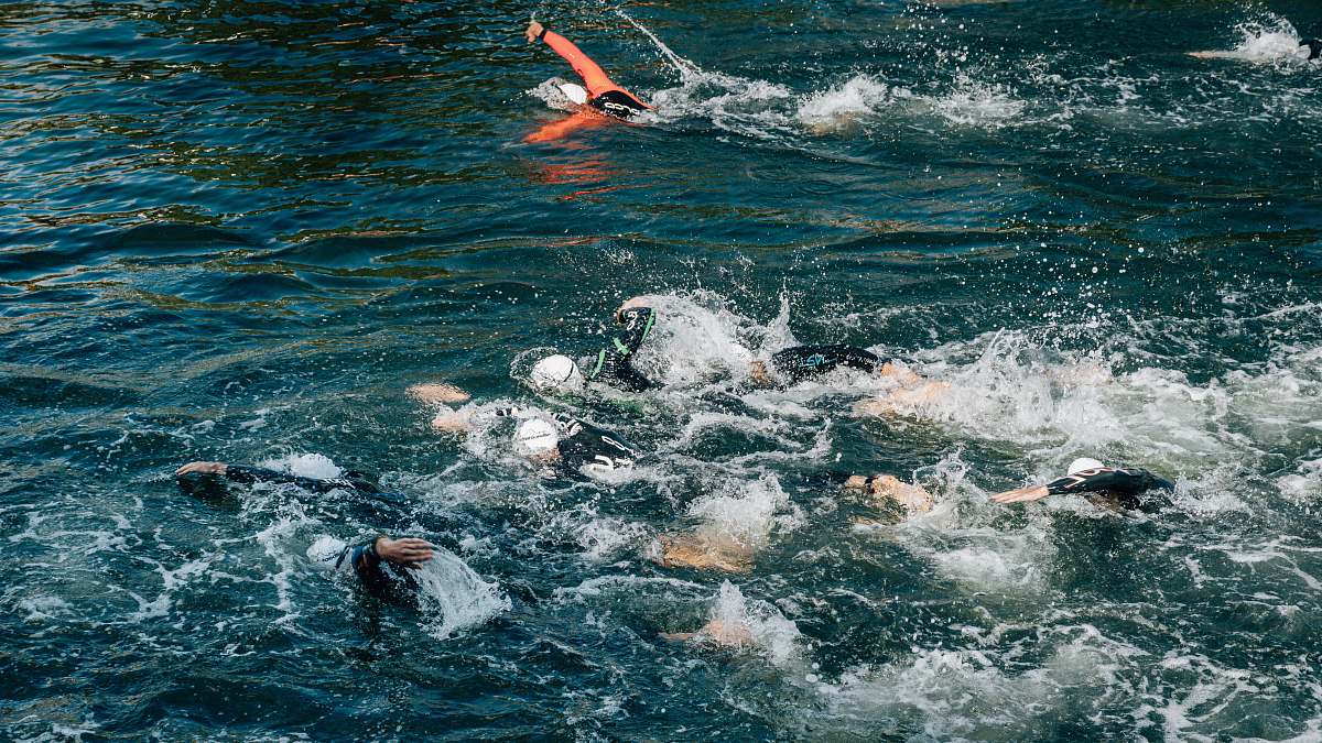 water people swimming during day person