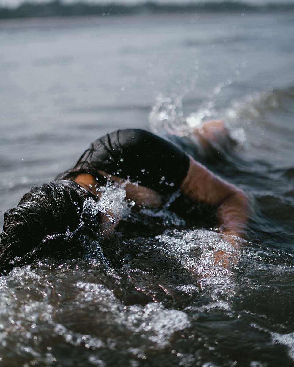 water woman half submerge on body of water human