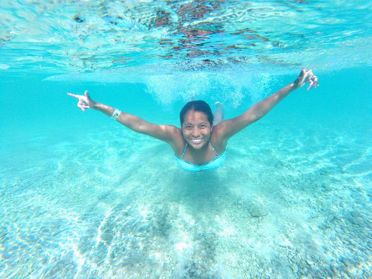 water woman teal wearing swimsuit swimming