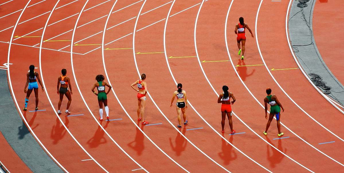 sport women running on race track during daytime running