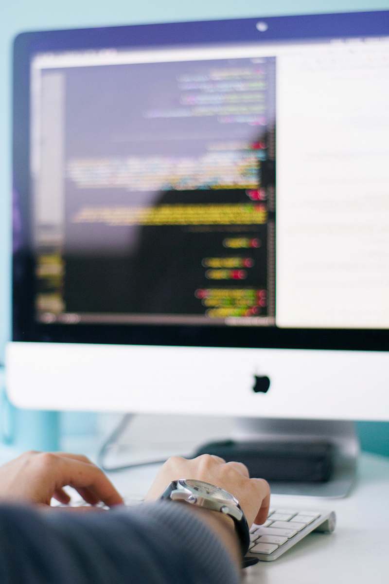 work person in front of iMac tech