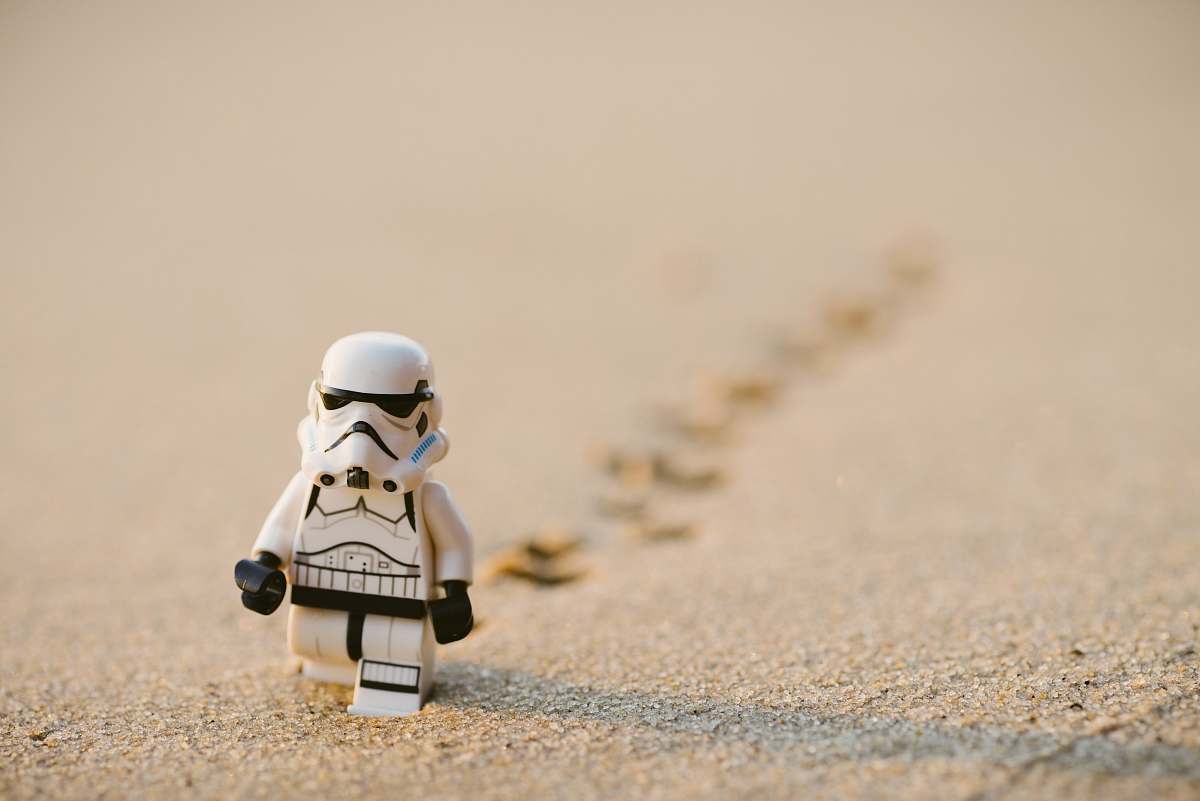 lego Stormtrooper minifigure walking on the sand human