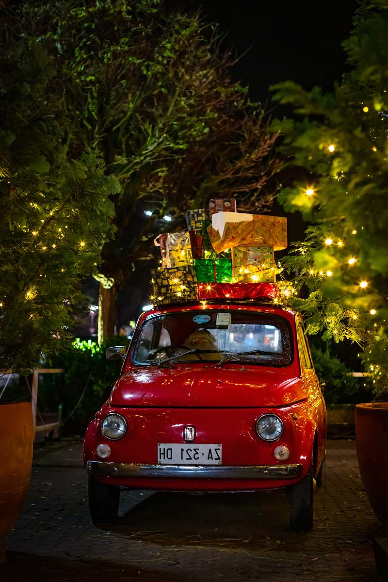 vehicle classic red FIAT 500 with christmas boxes on top car