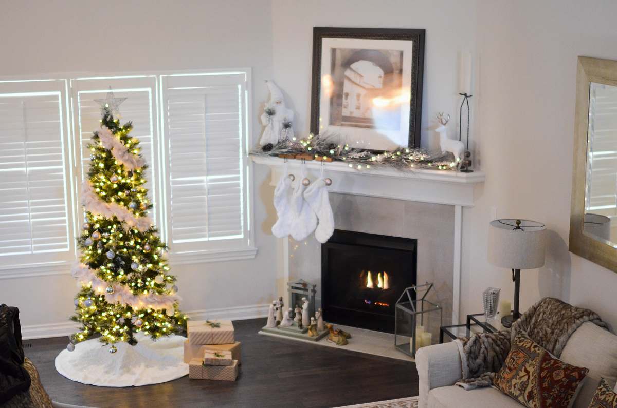 Fireplace Christmas Tree With String Lights Turned On Near