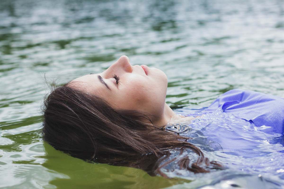 human close-up photography of woman on body of water person