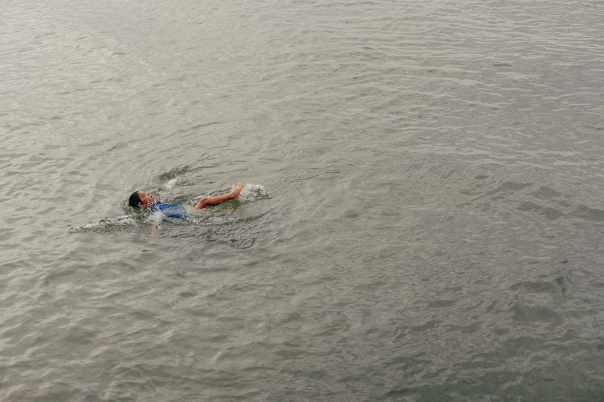 person person swimming on calm body of water human