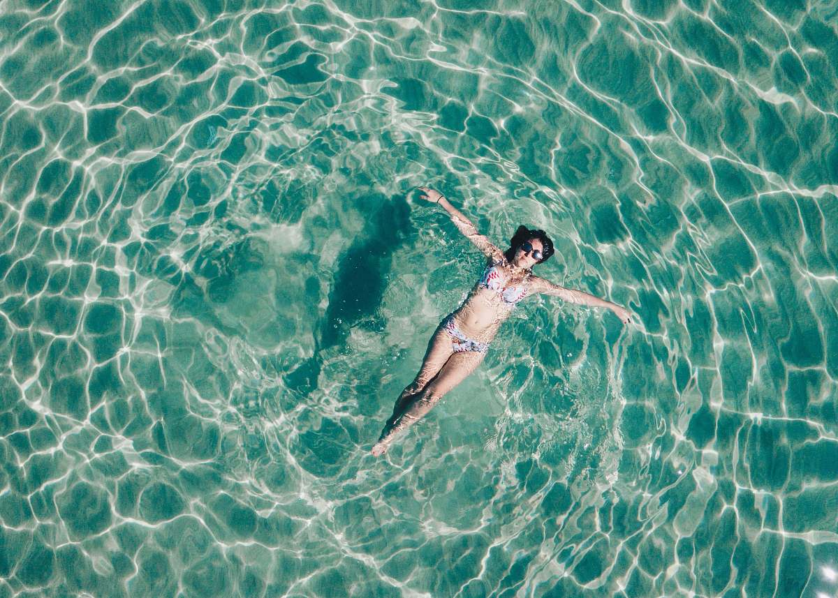 human woman floating on body of water sport