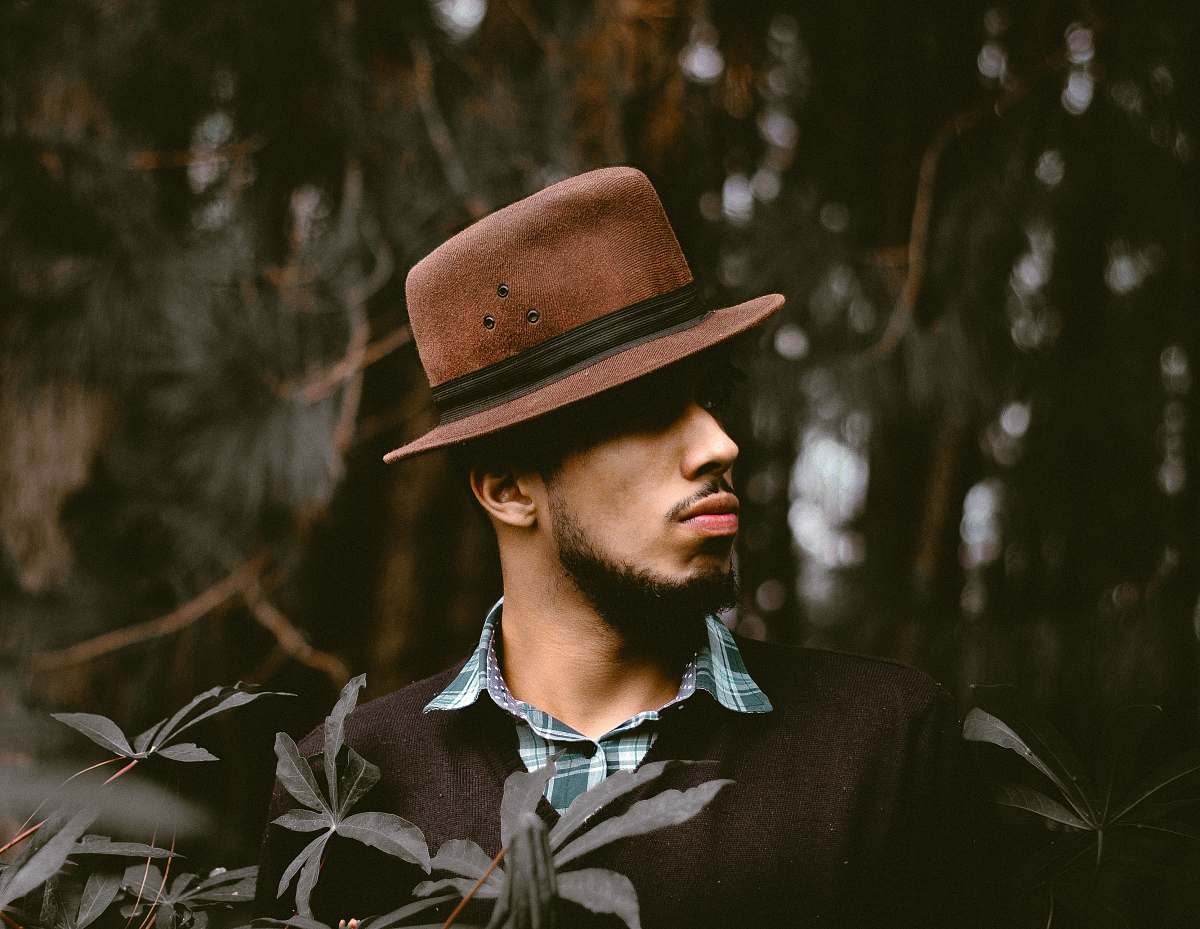 man man wearing brown hat standing front of tree male