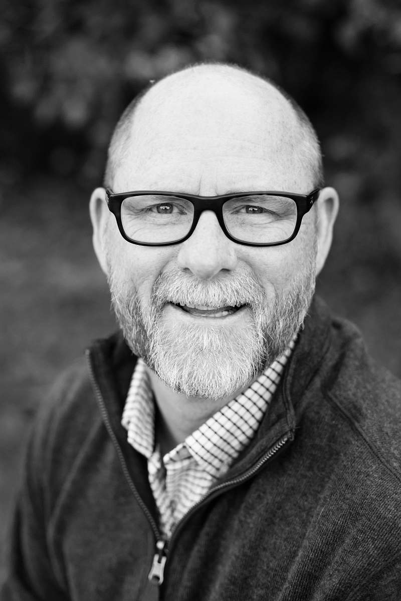 person grayscale of man wearing eyeglasses black-and-white