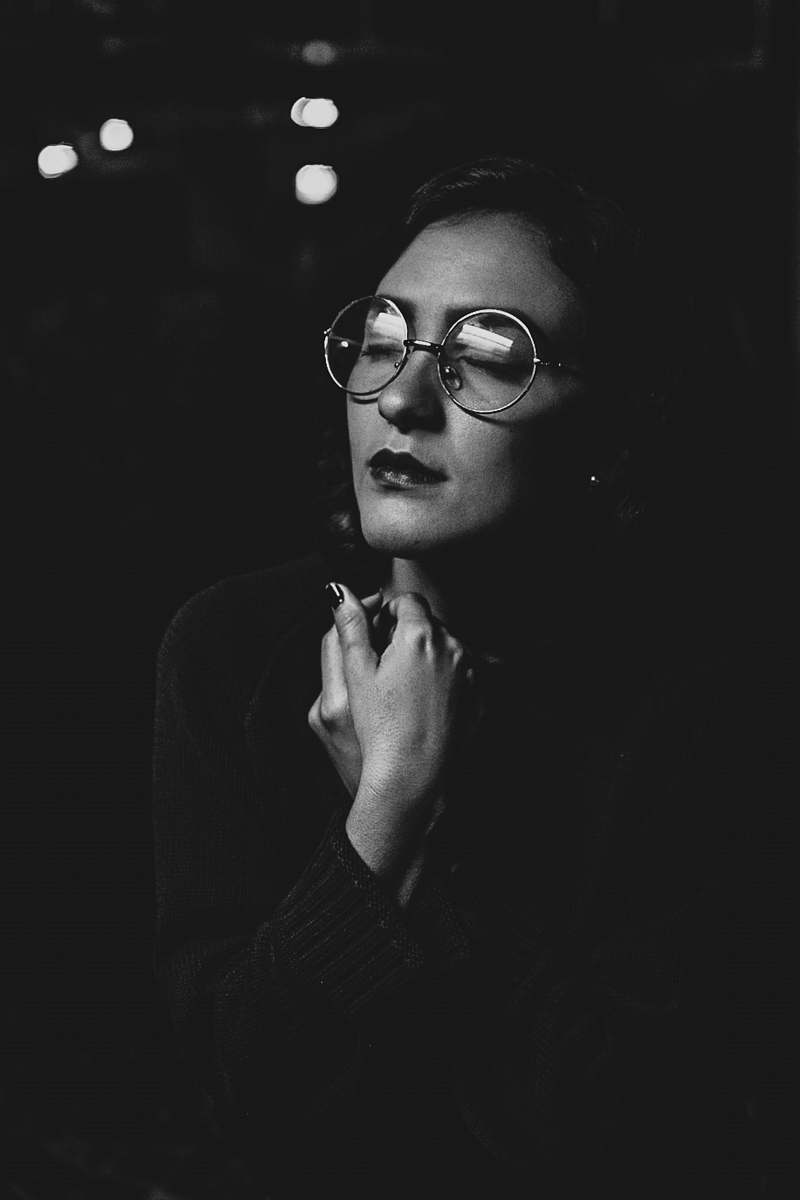 person grayscale photo of woman wearing eyeglasses black-and-white