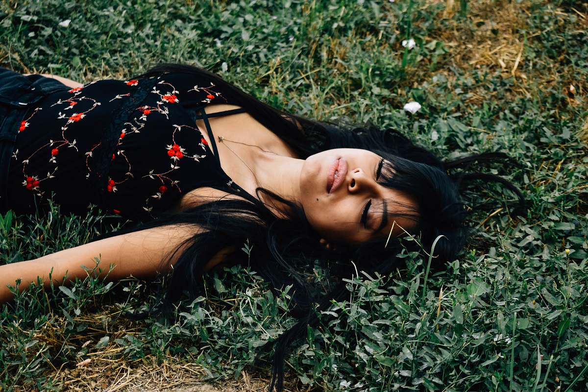 person woman lying on ground at daytime people