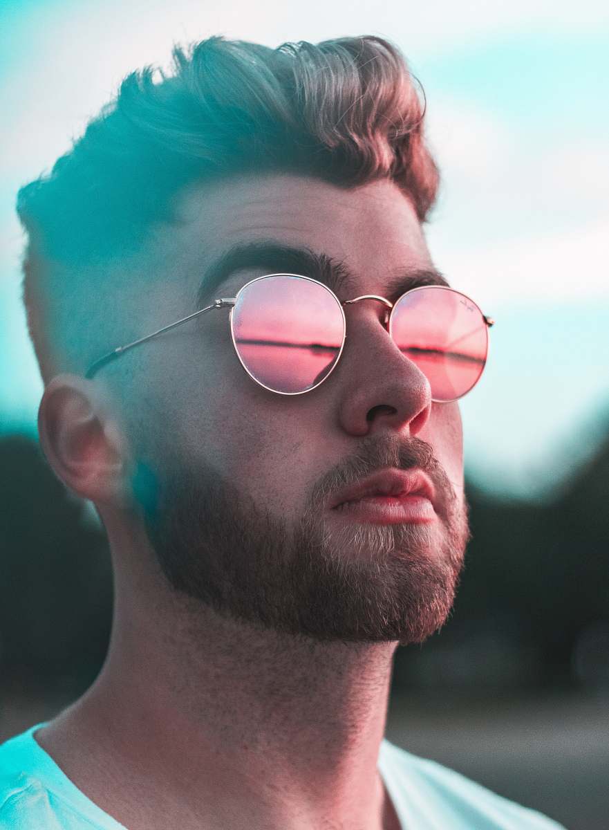 portrait close-up photography of man wearing red lens sunglasses human