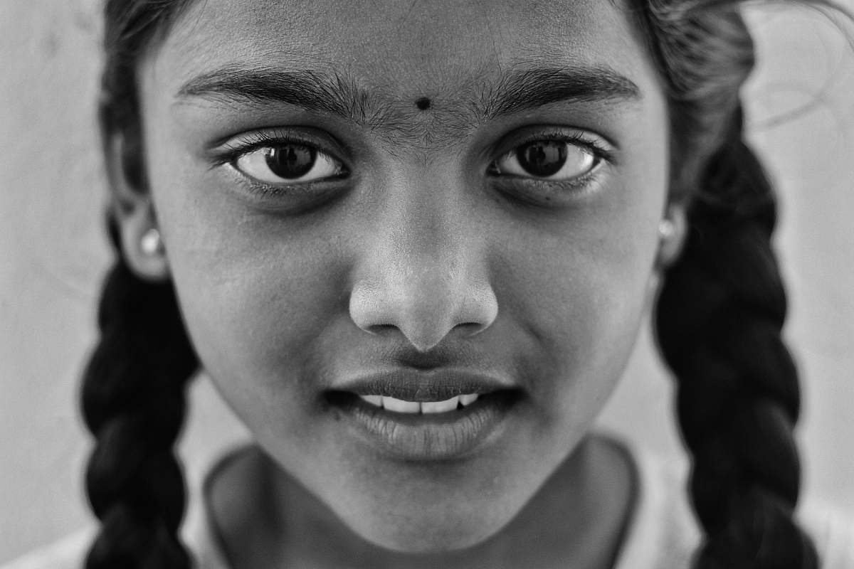 person grayscale photo of a girl taking a photo black-and-white