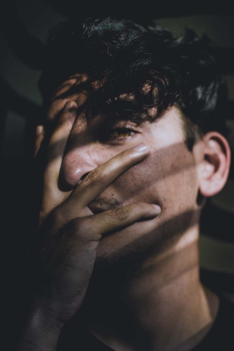 person man covering his face using his hand human