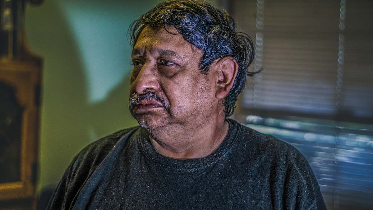 person man standing near window blinds human