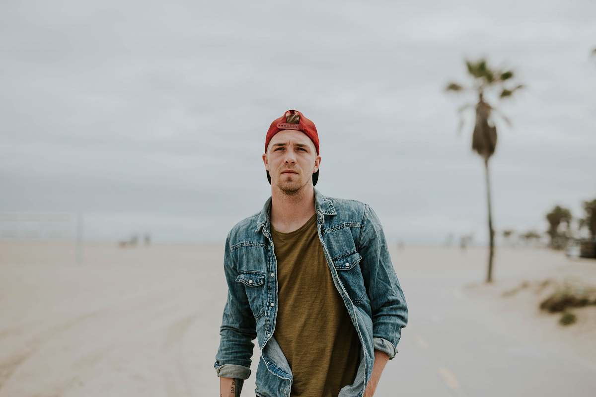 human man standing on road between sand person
