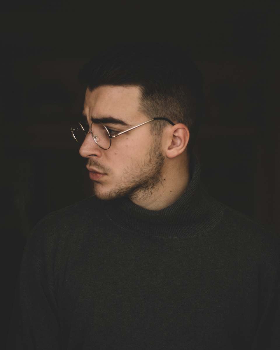 person man wearing black turtleneck top and silver framed eyeglasses human