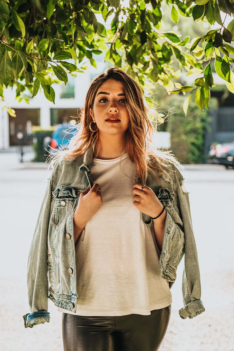 person portrait photography of woman wearing white shirt and gray denim jacket human