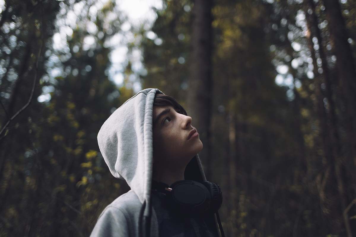 person shallow focus photo of man looking at trees human