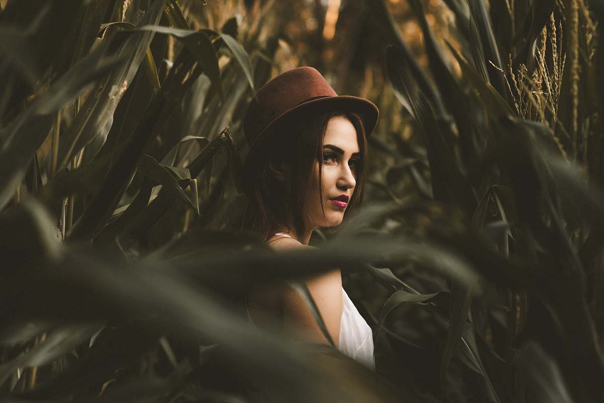 woman woman in white shirt with hat standing on corn field female
