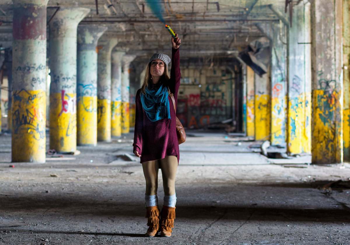 person woman standing on gray pavement woman