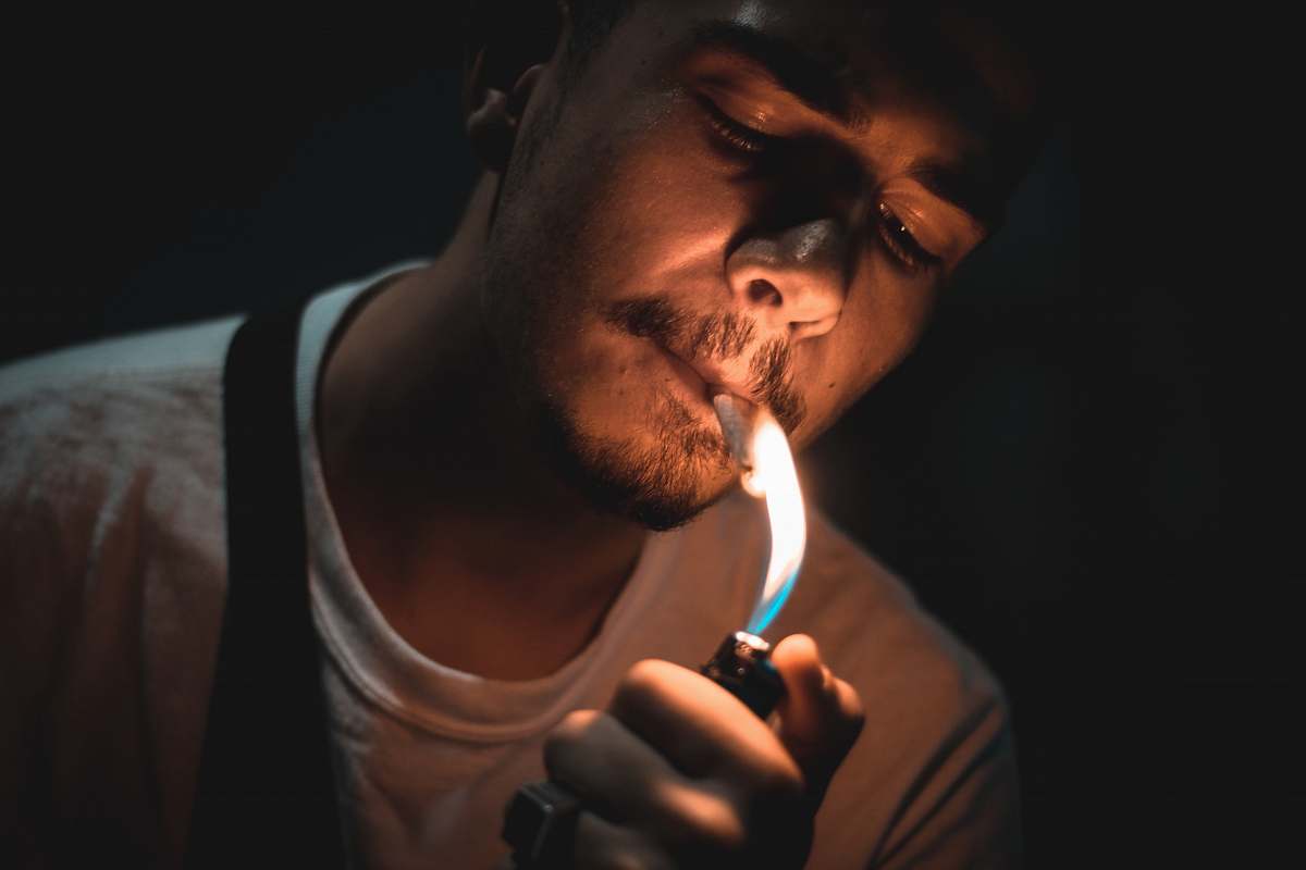 human man lighting cigarette people