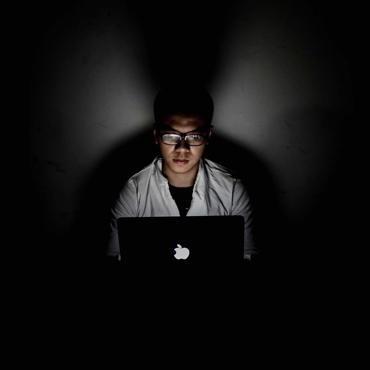 people man using MacBook inside dark room human