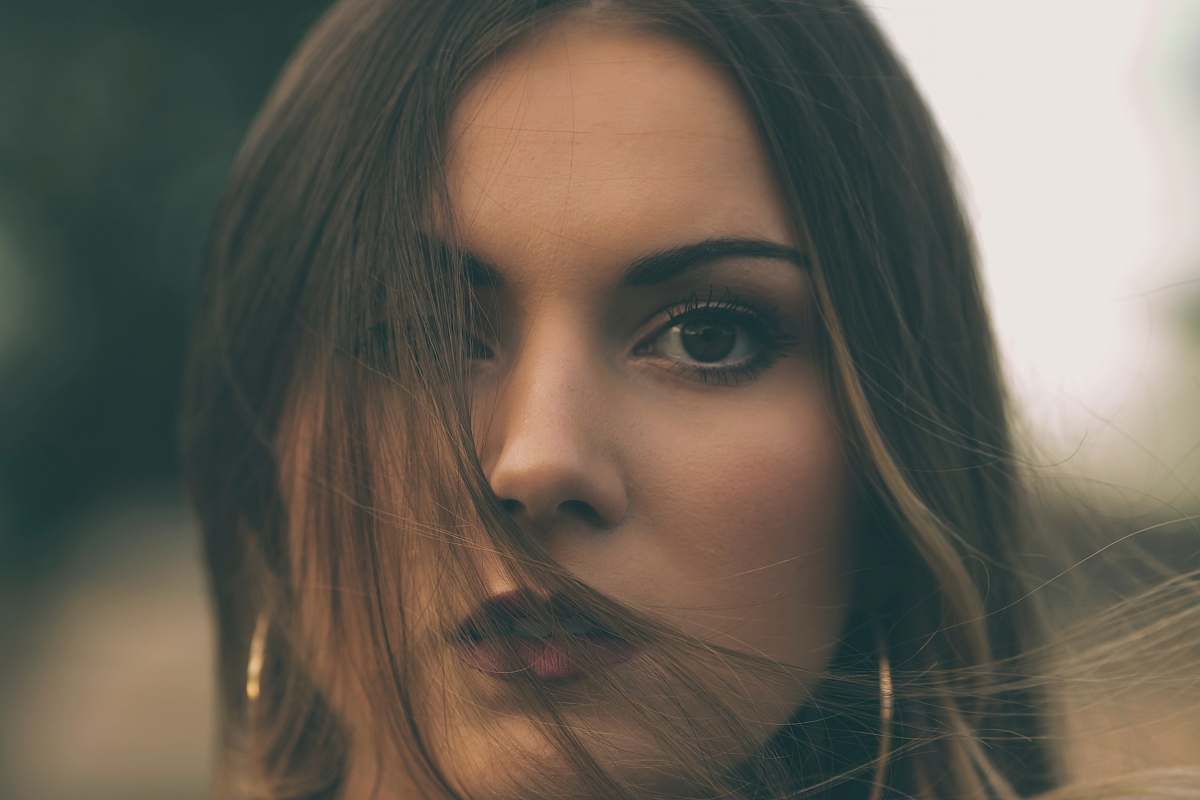 person shallow focus photo of woman in gold-colored hoop earrings face