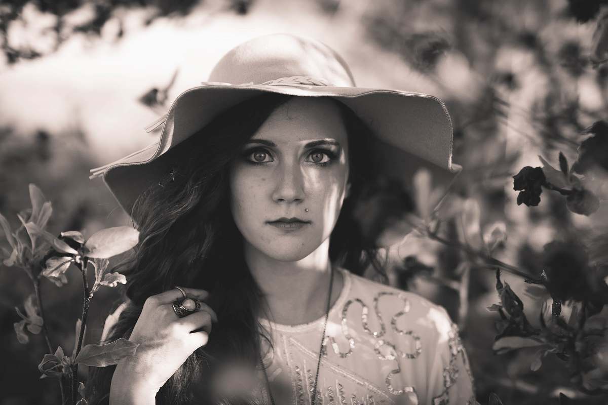 person grayscale photography of woman wearing sun hat human