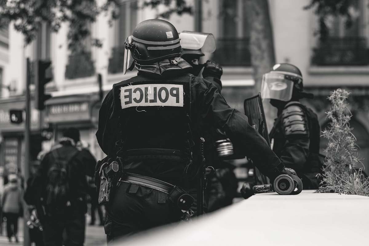 clothing grayscale photo of Police standing and leaning on wall black-and-white