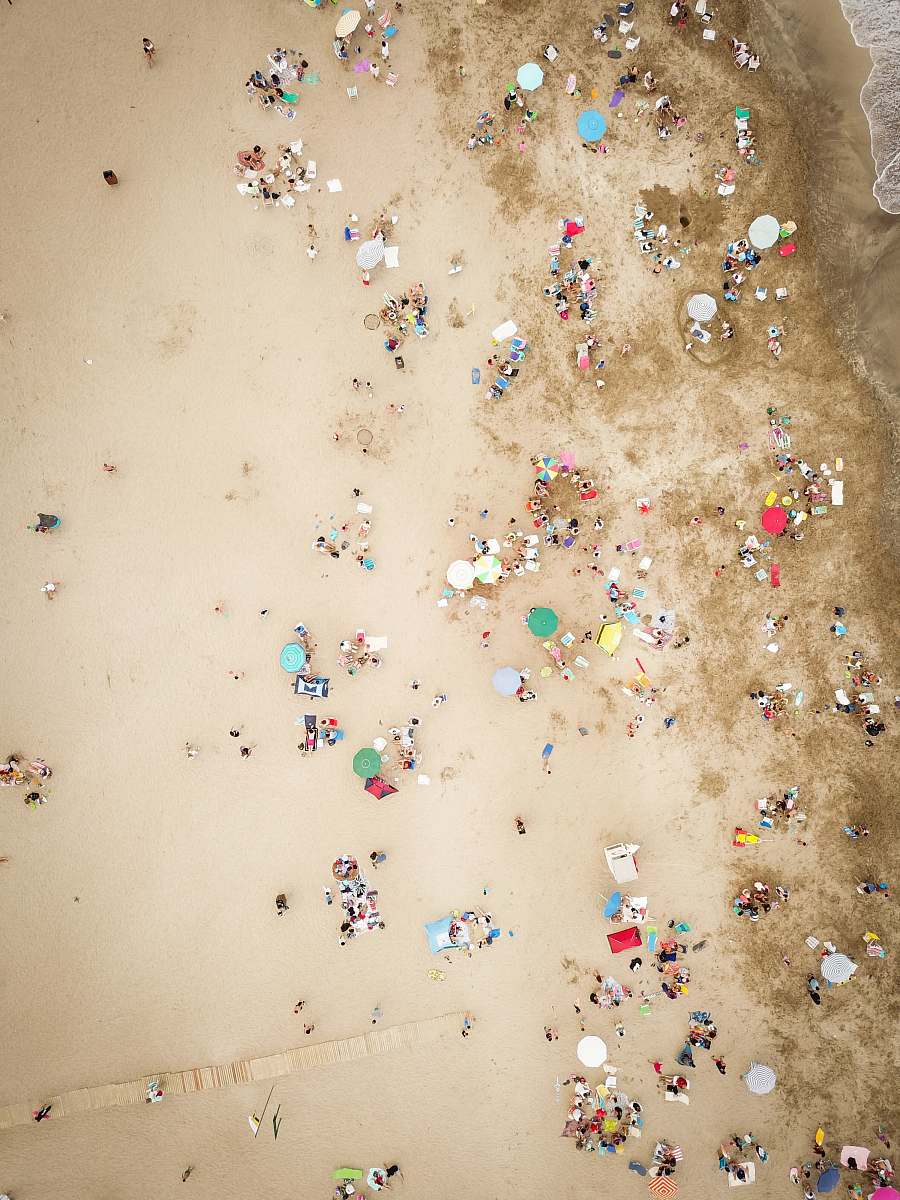 paper aerial photography of people on beach confetti