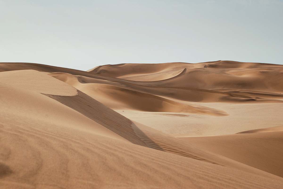 dune desert under clear blue sky during daytime sand dune