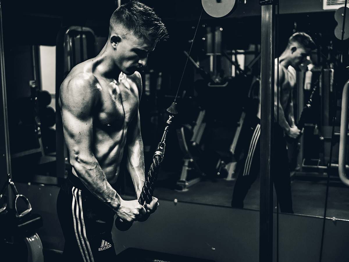 gym grayscale photo of man exercising grey