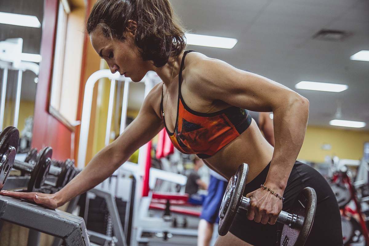 human woman seriously performing gym exercise person