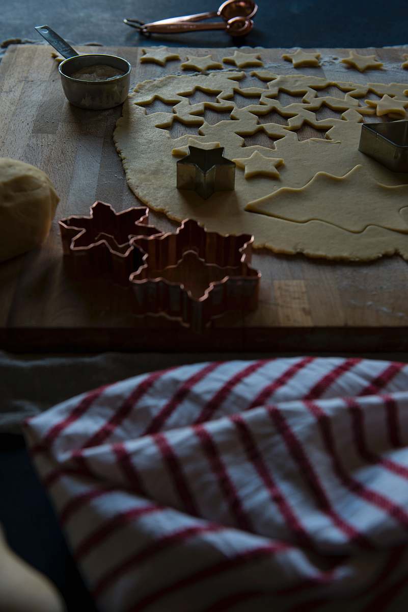 biscuit assorted-shape gray molds beside dough on chopping board cookie