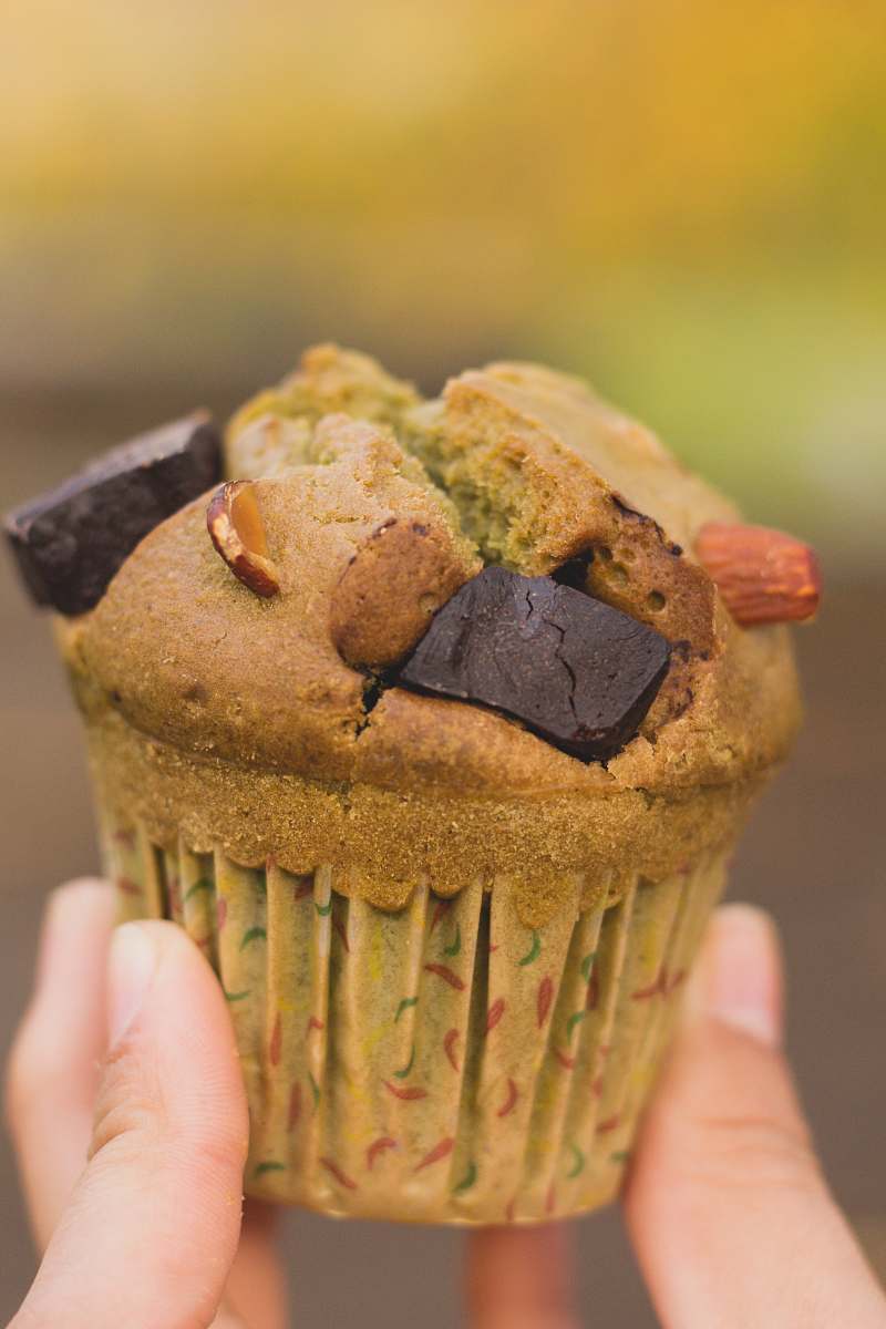 muffin person holding brown cupcake dessert