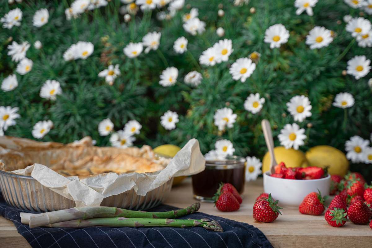 plant strawberry and white daisy flowers on brown woven basket strawberry