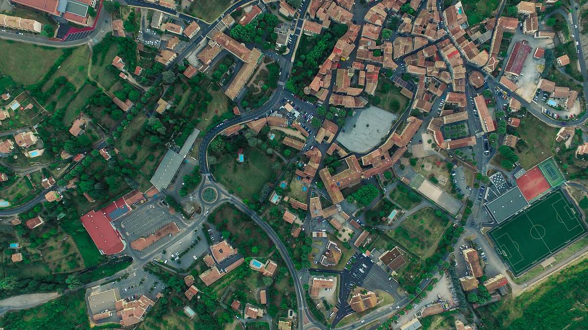 road aerial photography of city with houses aerial view