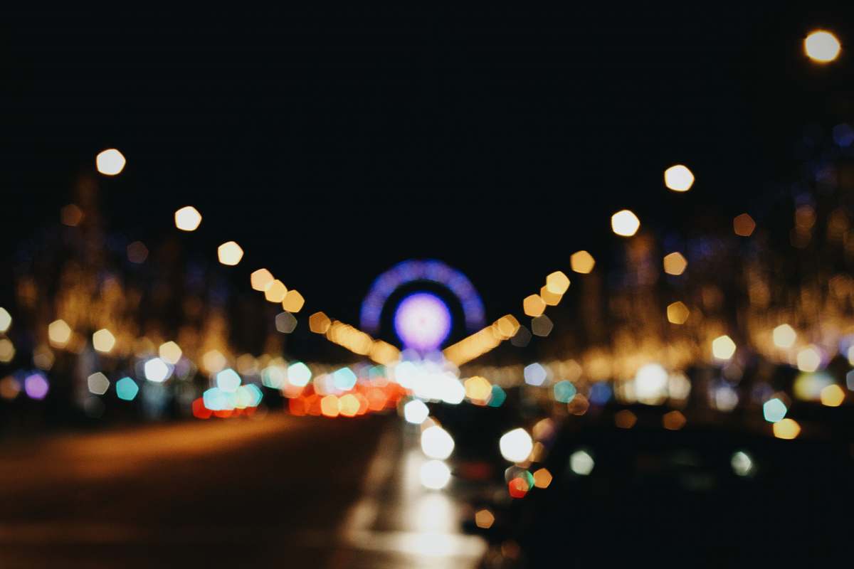 paris bokeh photography of lights on road during nighttime champs-élysées
