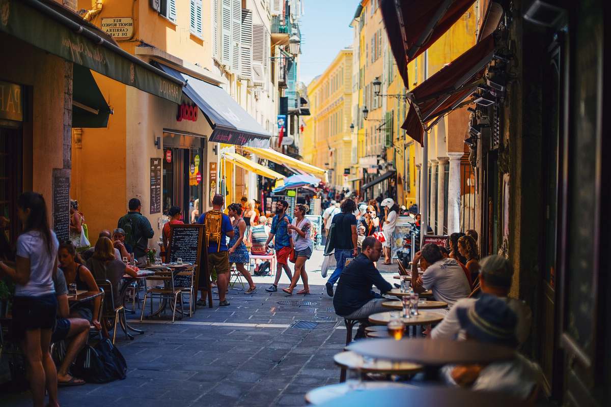people people on alleyway during daytime restaurant