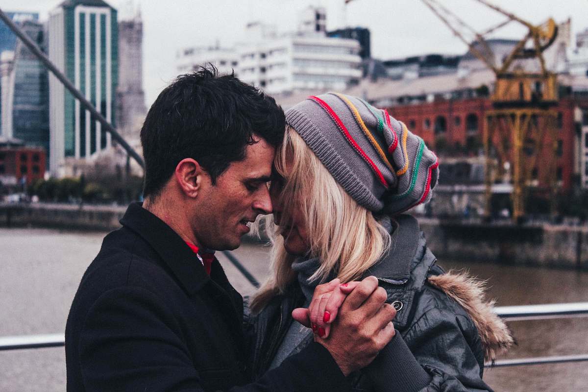 person man and woman dancing beside body of water people