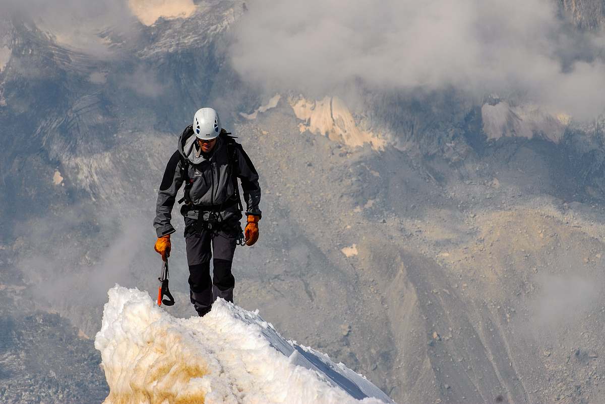 person man standing on snow during daytime people