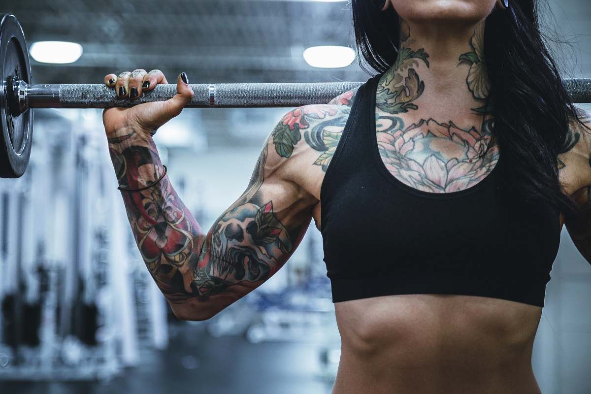 person woman carrying barbell people