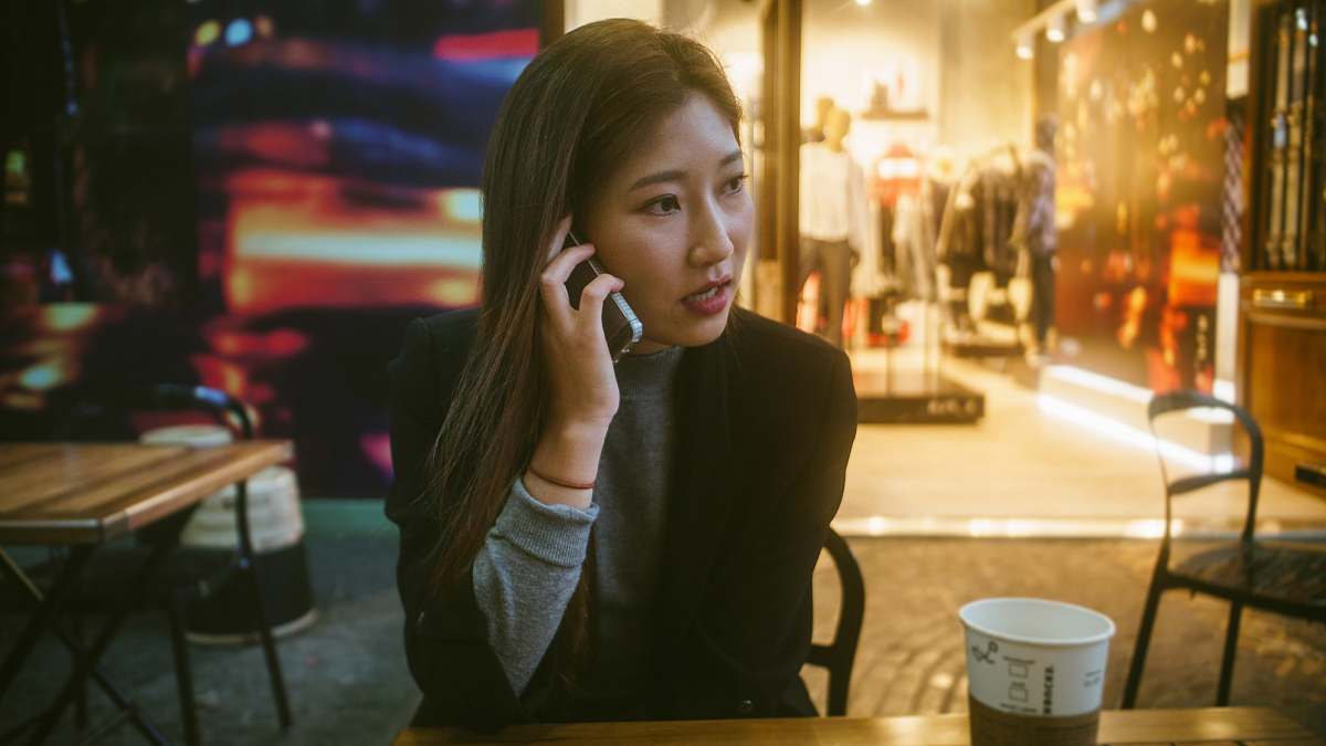 argentina woman talking on phone outdoor in front of store person