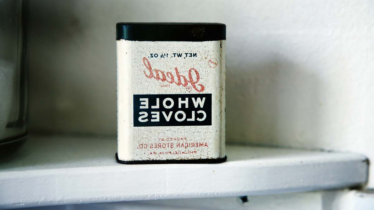 vintage Ideal Whole Cloves case on white shelf tin